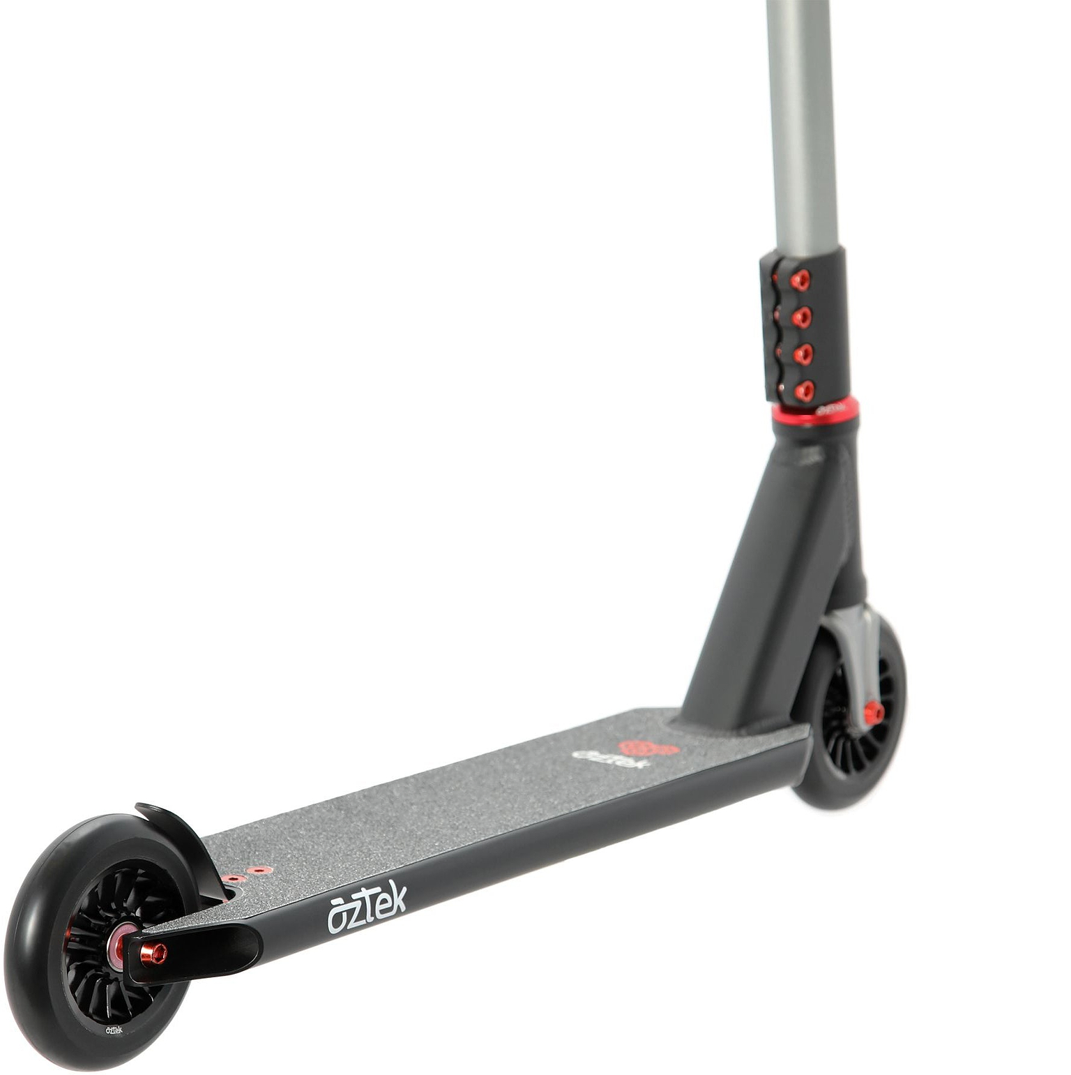 A close-up of the Aztek Corsa 2026 Complete Stunt Scooter - Satin Black shows its black and gray frame with striking red accents, featuring the deck, rear wheel, and part of the handlebar. This lightweight stunt scooter from Aztek includes grip tape on the deck and has “OZTEK” printed on the side, making it an excellent option for park scooter enthusiasts.