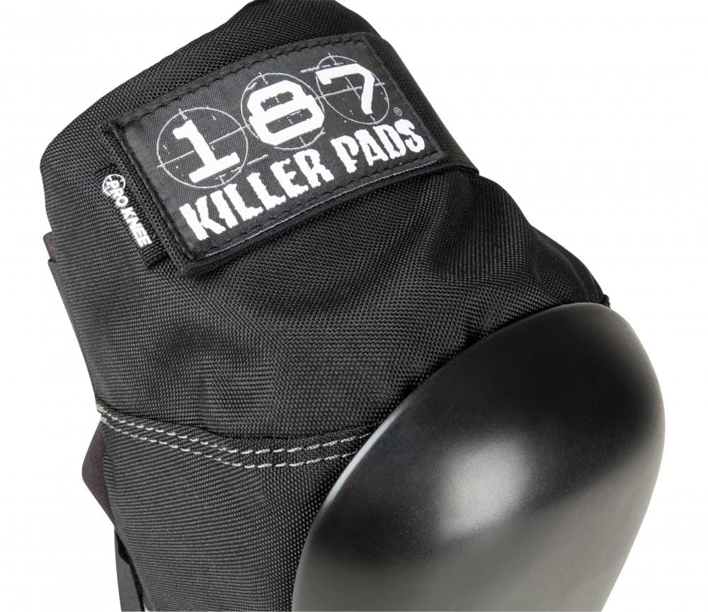 Close-up of a black knee pad from the 187 Killer Pro Knee Skate Protection Pads collection, showcasing a "187" logo on its fabric tag. Designed to cater to action sports enthusiasts, it boasts durable stitching and a smooth, rounded cap for dependable protection against significant impacts.