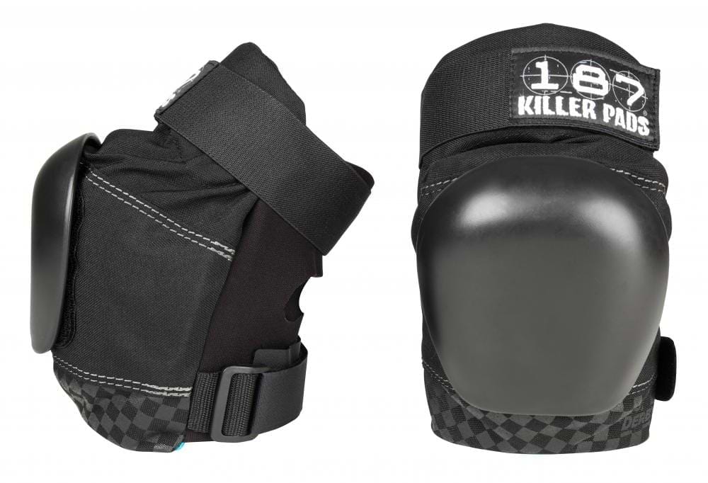 Two 187 Killer Pro Derby Knee Protection Pads in black are displayed, featuring adjustable straps and a rugged design suitable for action sports. The brand "187" is prominently visible on the upper section. One knee pad stands upright while the other lies on its side, highlighting the V-22™ Dual Density Foam cushioning for exceptional protection.