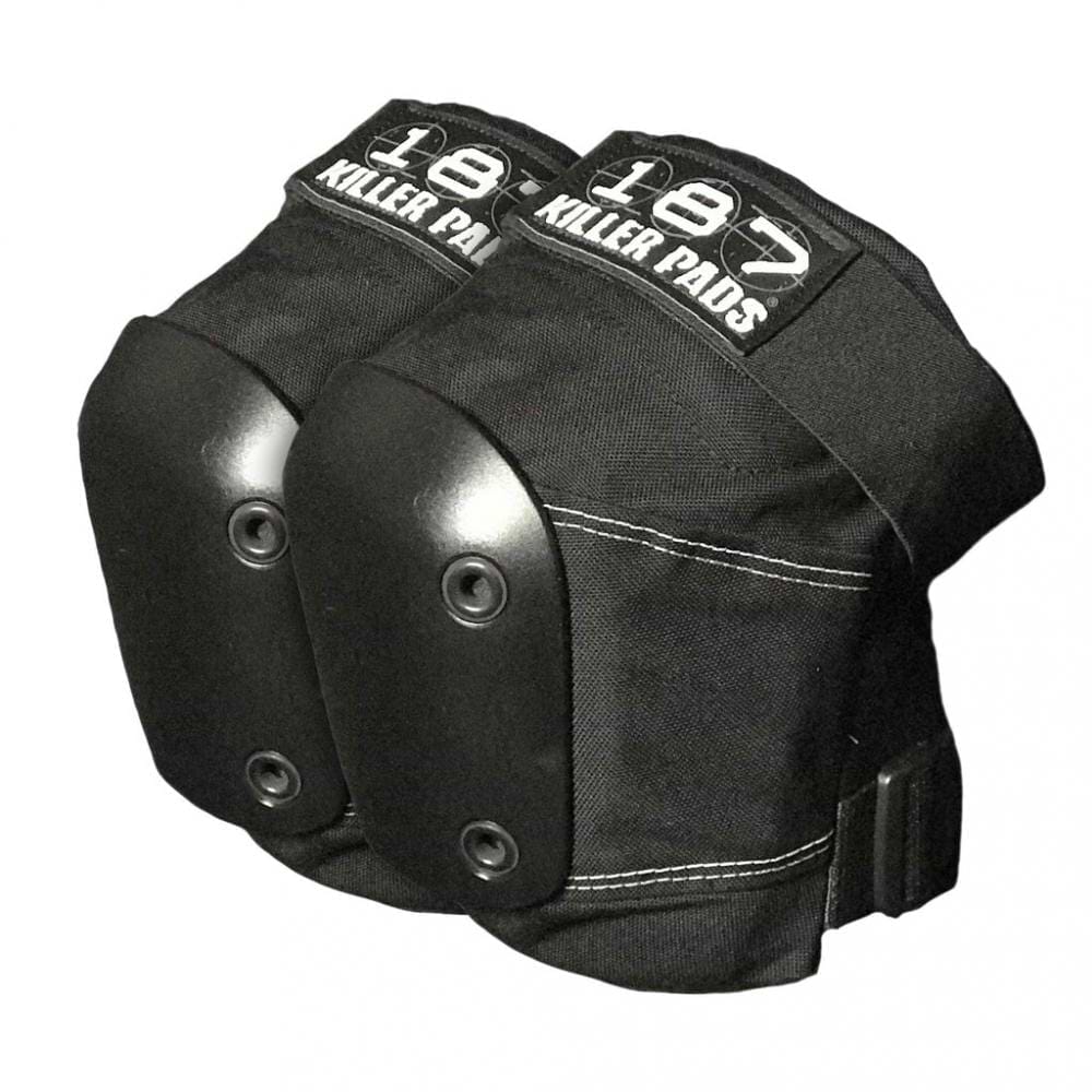 A pair of 187 Killer Slim Knee Skate Protection Pads in black, featuring hard plastic caps and adjustable straps, is set against a white background. Each pad displays the "187" label in white text, showcasing their exceptional skate protection with a memory foam system for added comfort.