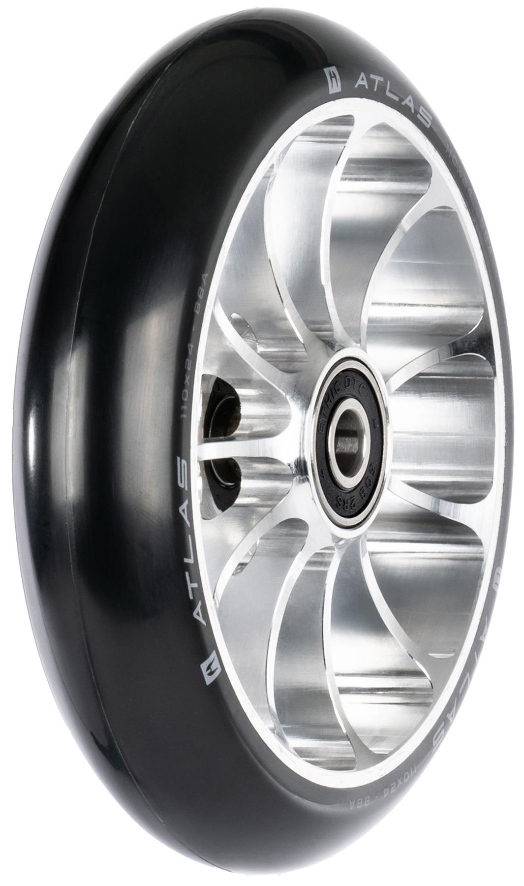 A close-up of the Ethic DTC Atlas 110mm Stunt Scooter Wheel - Raw shows its shiny black and silver finish, intricate metal spokes, lightweight design, built-in bearing, and “ATLAS” branding.