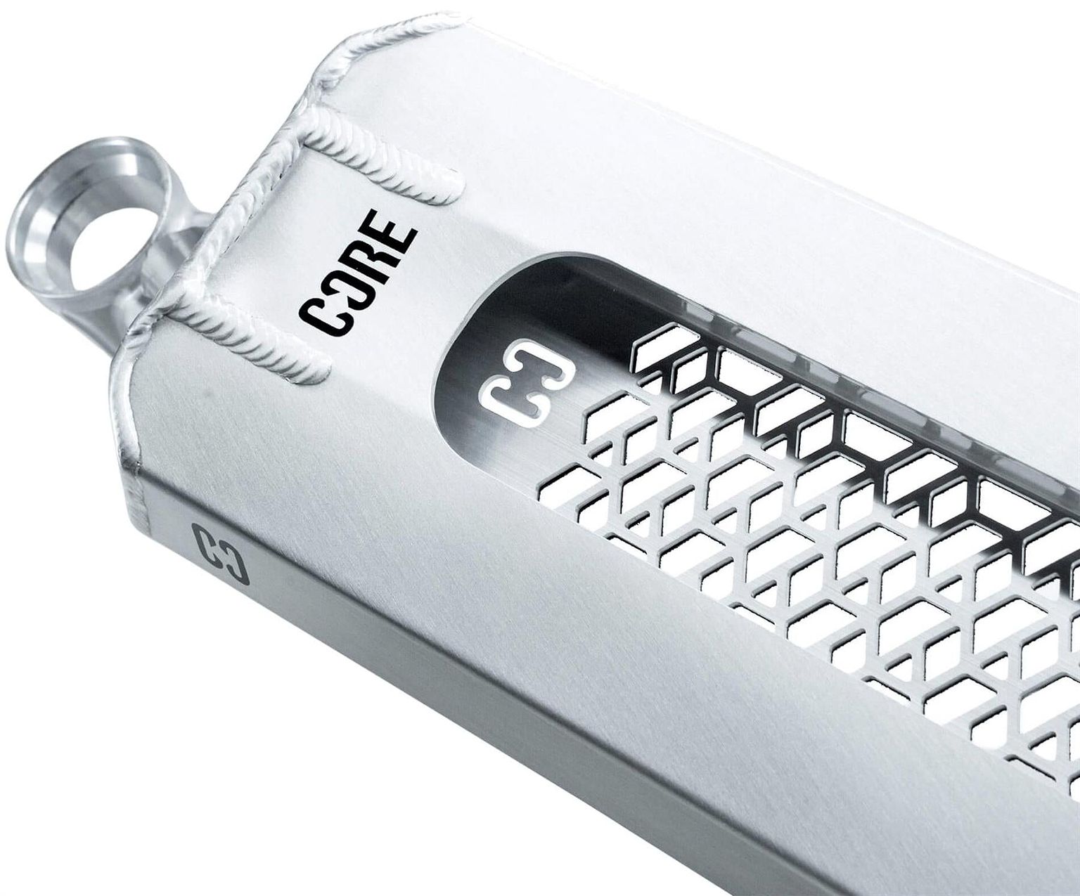 Close-up of a metallic grater with a hexagonal pattern, labeled “CORE” and “C3.” Its sleek, modern style mirrors the precision engineering of the CORE SL3 Forged Polished Stunt Scooter Deck by CORE. Includes an easy-grip loop handle.