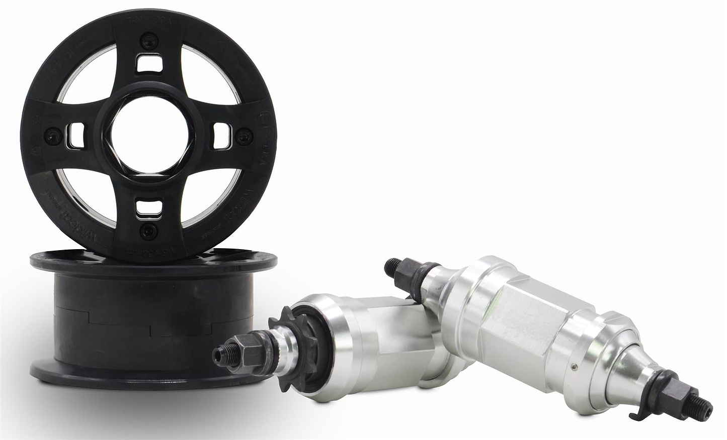 Two black plastic pulley wheels—one upright, one flat—are next to two silver parts with black threaded ends, all essential for the Wildcat OG 3A Mini BMX Bike - Galaxy Blue by Wildcat, showcased on a plain white background.