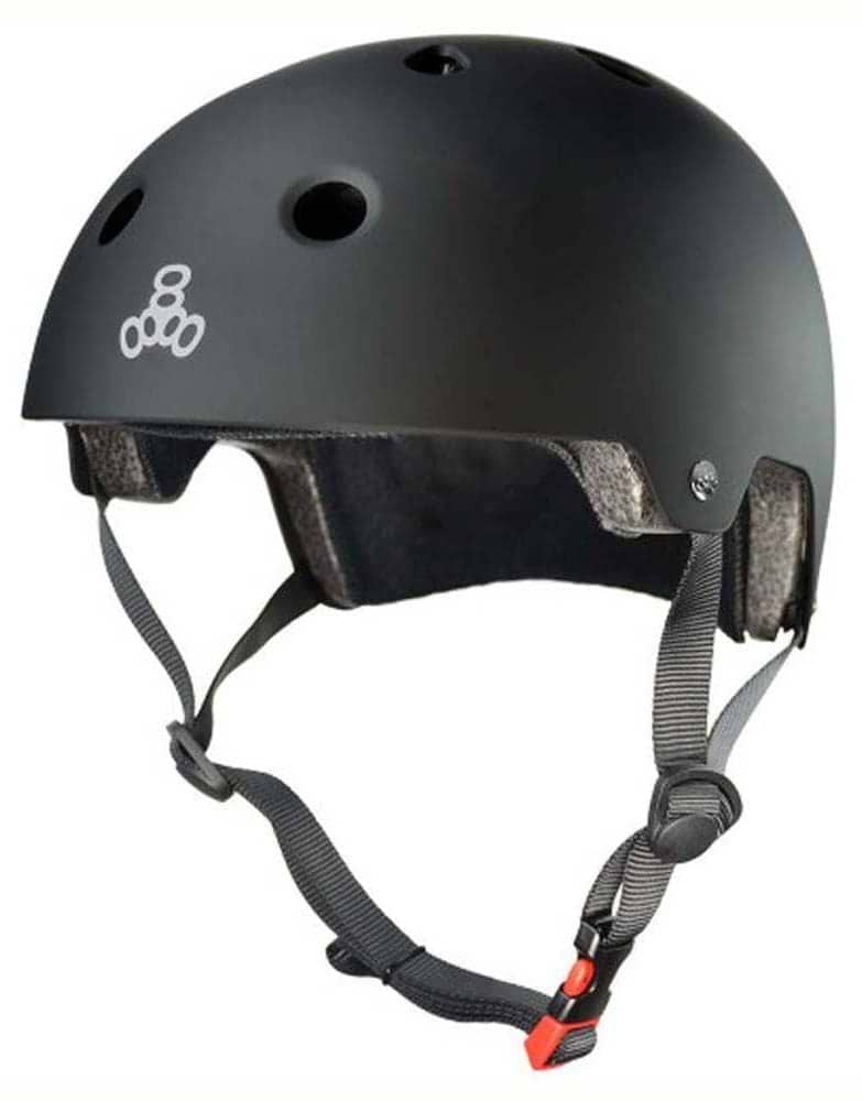 The Triple 8 Dual Certified Brainsaver Helmet - All Black Rubber features air vents, grey adjustable straps, a red buckle, a white front logo, and an EPS liner for enhanced protection.