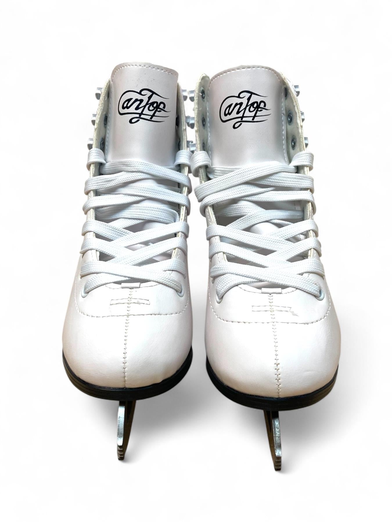 A pair of Supreme Cantop Junior Figure Ice Skates in white/silver, featuring synthetic leather boots, laces, and stainless-steel blades are shown from the front with the "Supreme" logo on their tongues against a white background.