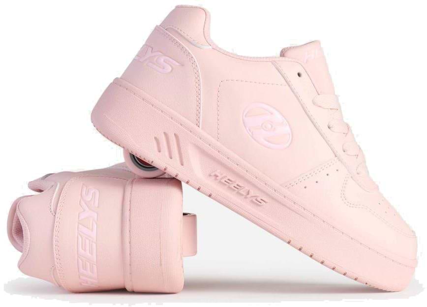 A pair of Heelys Kama Girls Shoes - Pink by Heelys, with one upright and the other on its side, displays court-style shoes featuring hidden low-profile wheels in the sole.