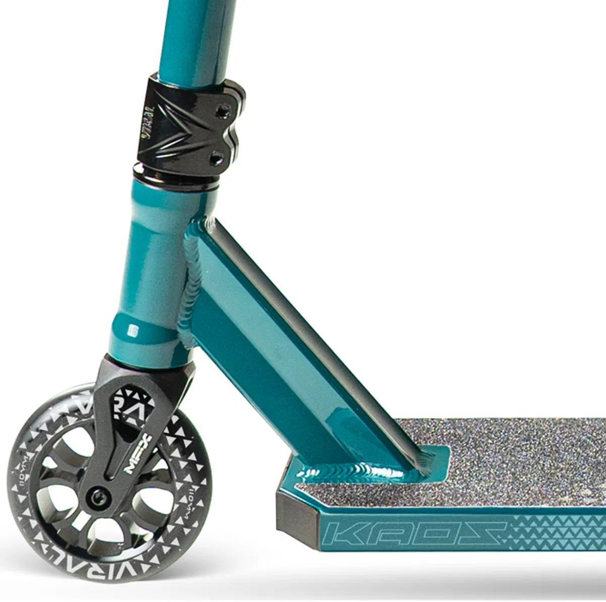 Close-up of the Madd Gear Viral KAOS Complete Stunt Scooter - Denim, featuring the front wheel, handlebar, clamp, angled fork, and textured deck with "KAOS" branding.