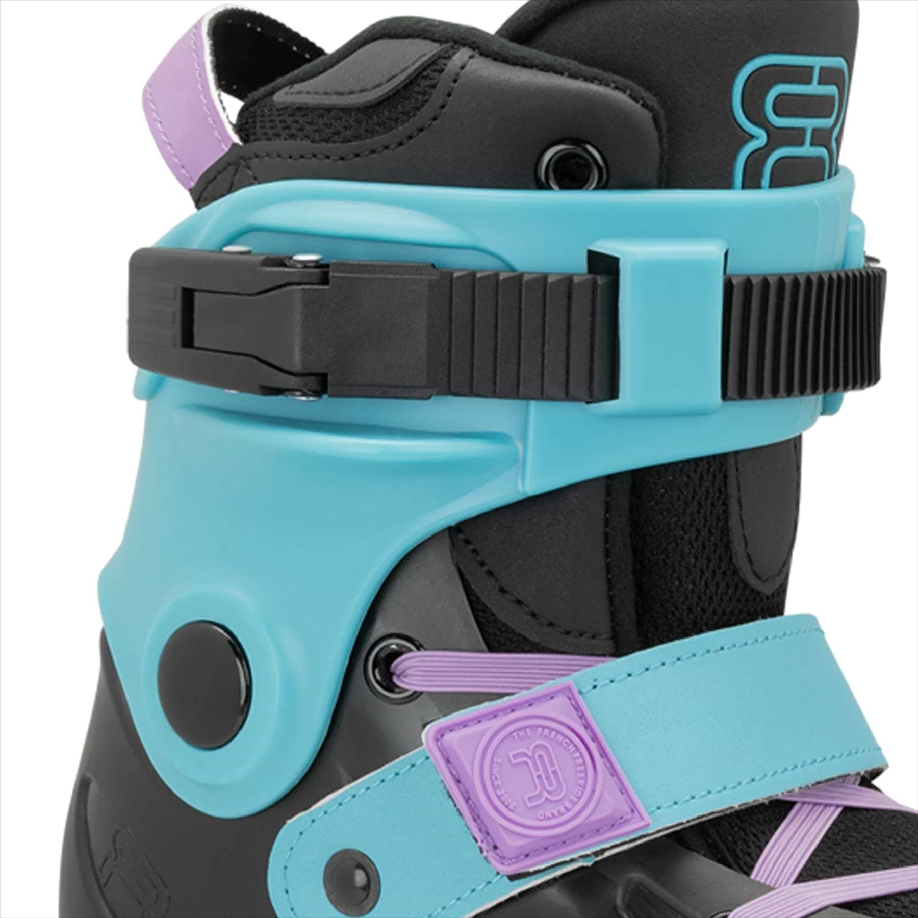Close-up of the FR Skates Junior Adjustable Inline Skates, Luminous Black Pearl model, showcasing a stylish turquoise shell with a black adjustable buckle and strap. It features purple accents, including laces for comfort and support, all mounted on X2R rocker-able frames.