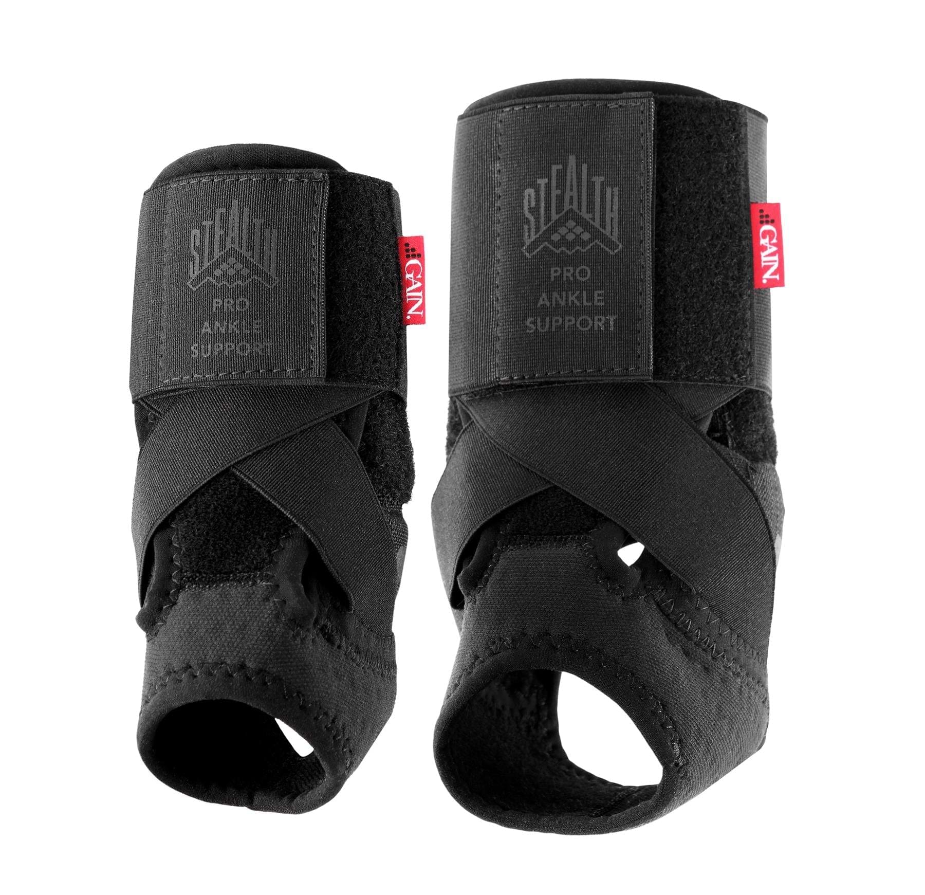 Two black GAIN Protection Stealth Pro Adult Ankle Support braces with crisscross straps, open-heel design, “STEALTH Pro Ankle Support” text, and red GAIN tags for enhanced support and impact protection.
