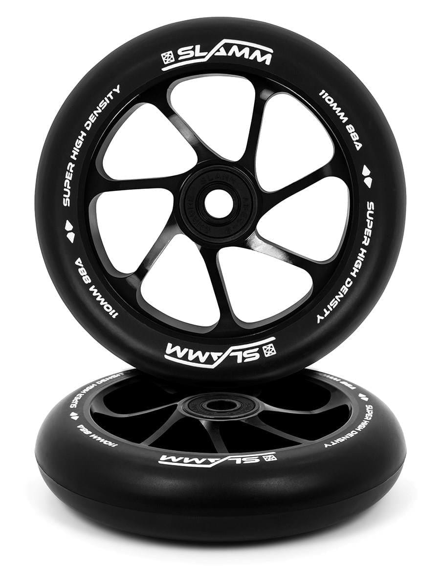 Featuring the sleek design and brand logo of Slamm, two 110mm scooter wheels are presented in black with white text, reading "SLAMM" and "SUPER HIGH DENSITY." Constructed from high-rebound PU with a durable aluminum core, one wheel stands upright while the other is laid flat.
