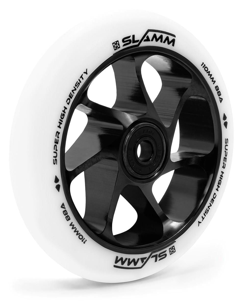 The Slamm Team 110mm Stunt Scooter Wheel in White and Black features a six-spoke design with a durable Aluminium Core and smooth High-Rebound PU. The black wheel has a white outer edge with "SLAMM" and "SUPER HIGH DENSITY" displayed in black lettering.