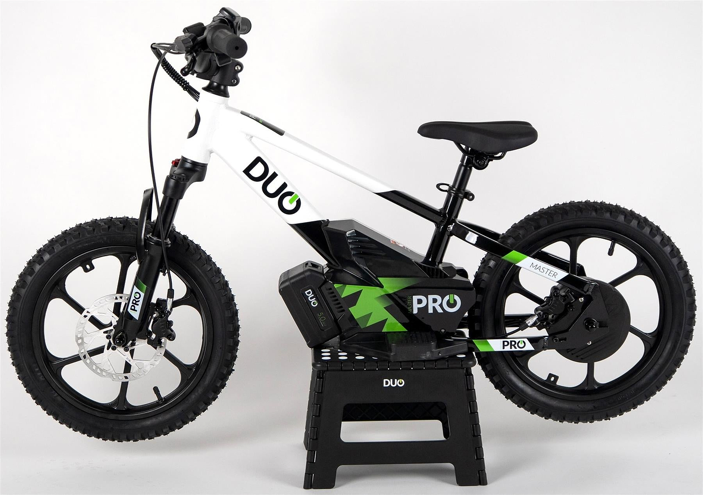 The Duo 16" Master Pro Kids Electric Balance Bike, in white and black with thick tires and disc brakes, is shown on a black stand against a plain white background.