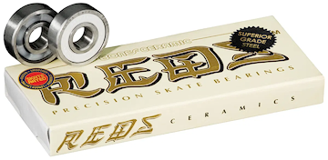A cream-colored box labeled "Bones Ceramic Super REDS Skateboard Bearings - 8 Pack" from Bones is shown with two high-speed bearings beside it. Gold and black text and a "Skate Rated" sticker highlight these premium ceramic bearings.