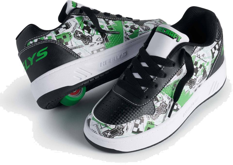 The Heelys x Minecraft Kama Boys Shoes in white, black, and green feature bold graphic patterns and a visible green wheel in the sole, blending Heelys' roller design with gamer-inspired Minecraft style.