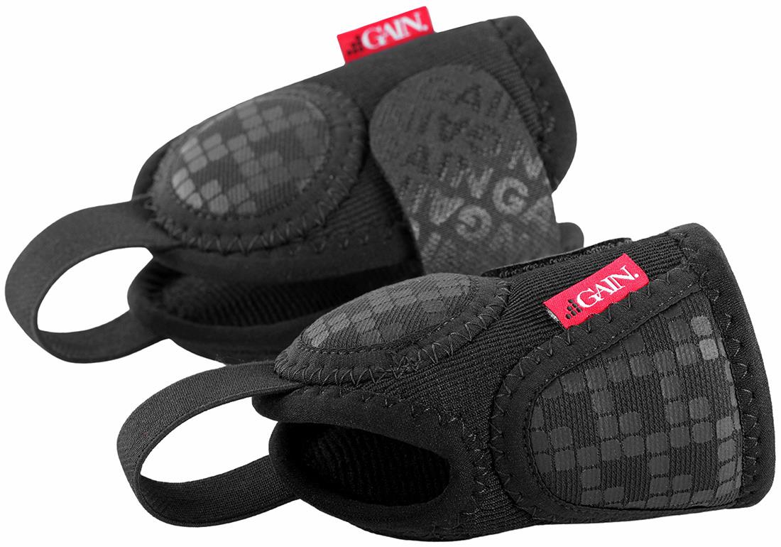 A pair of black GAIN Protection Pro Junior Ankle Protectors with padded support and red GAIN tags. Designed for impact protection, these junior ankle protectors feature a textured surface for better grip during sports or training.