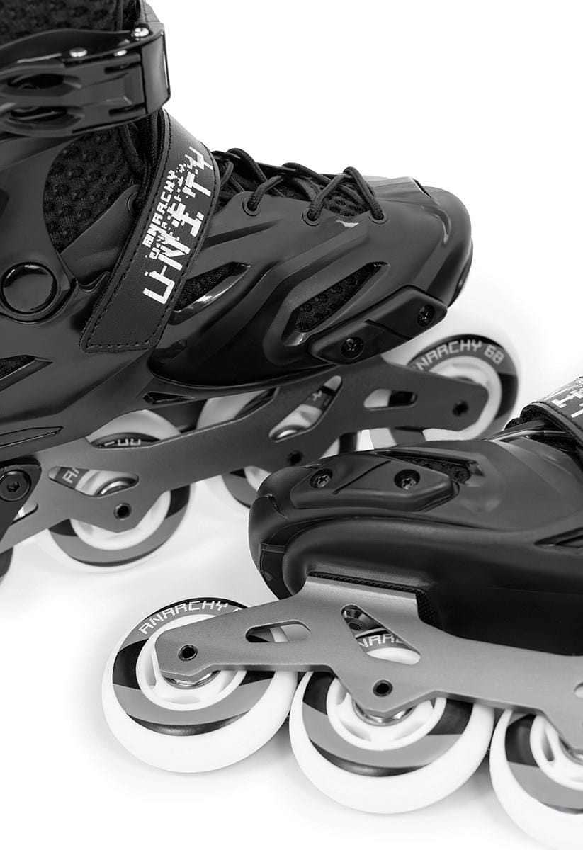 Close-up of Anarchy Unity Adjustable Inline Skates - Black, showcasing detailed boot and aluminum frame designs. The visible wheels are labeled "Anarchy 68," emphasizing the sleek and sturdy construction of these inline skates.