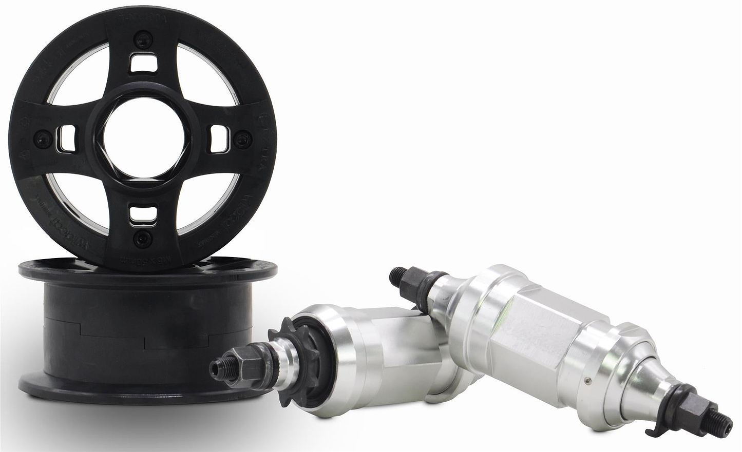 Three Wildcat OG 3A Mini BMX Bike mechanical parts are shown: two silver metal, threaded cylinders and two black plastic rounds, ideal for use with the Royal Red Wildcat bike.