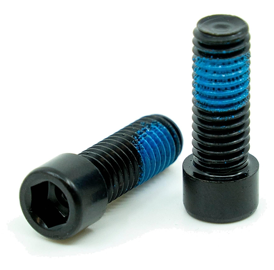 Two CORE Replacement M8 Stunt Scooter Clamp Bolts from CORE, shown as a pair with blue thread-locking compound, black high tensile steel, one upright and one lying down on a white background—ideal for securing stunt scooter clamps.