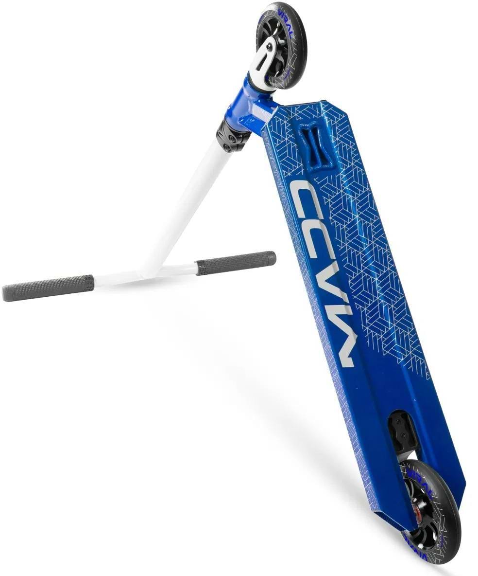 The Madd Gear (MGP) Viral Purge Complete Stunt Scooter in cobalt is angled for skatepark action, with one wheel on the ground, tilted handlebars, a geometric-patterned deck, and bold "VIRAL PURGE" lettering.