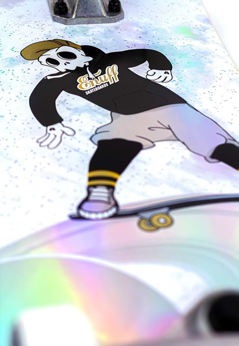 The Enuff Skully Hologram White Mini Complete Skateboard (7.25" x 29.5") features a cartoon character with a skull-like face in skateboarding attire, including a beanie and hoodie labeled "Snuff." It's ideal for beginners due to its high-quality components.