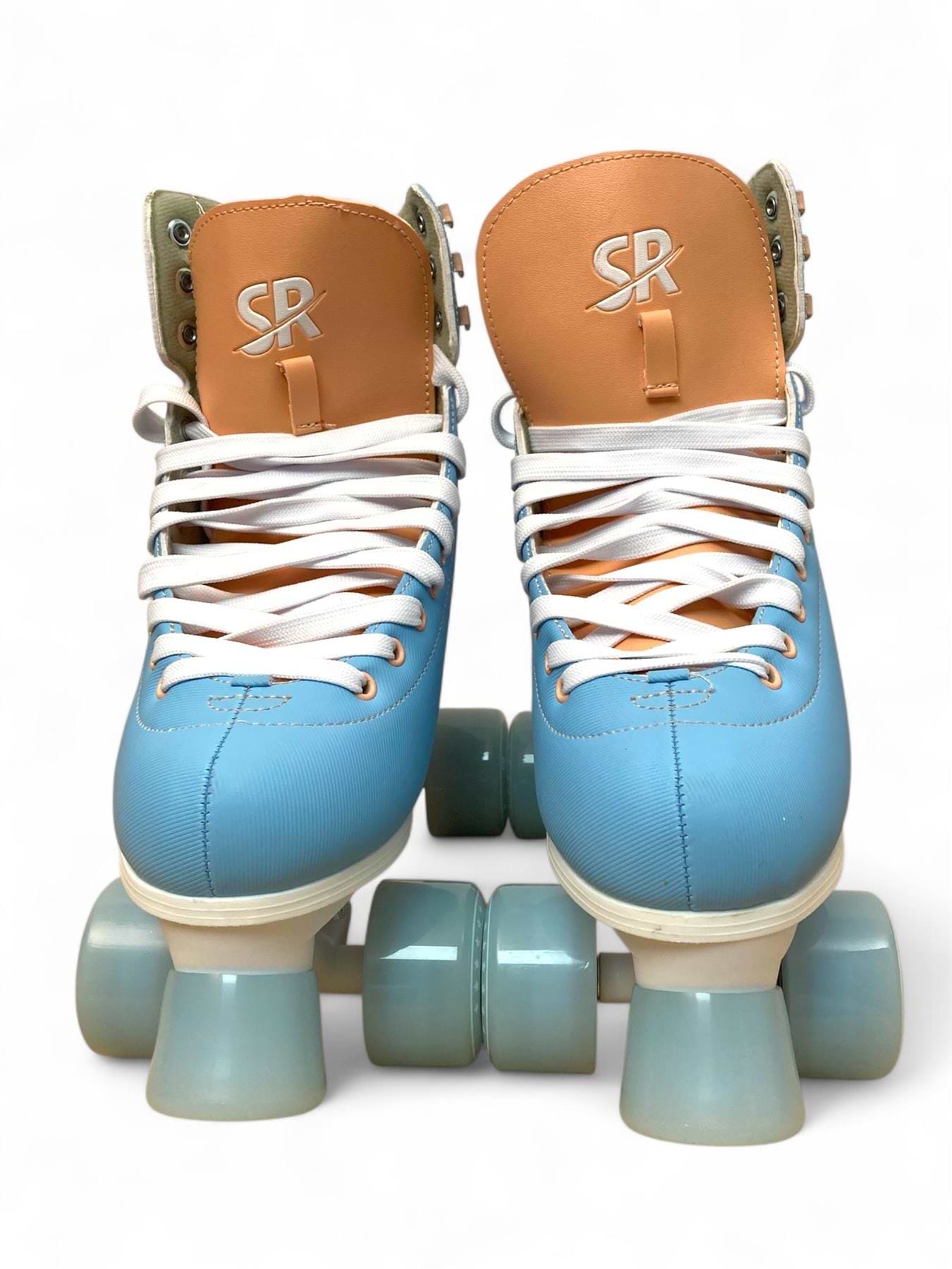 The Supreme Malibu Quad Roller Skates in Light Blue by Supreme feature white laces and large light blue wheels, positioned upright on a white background—ideal for beginners or recreational skating.