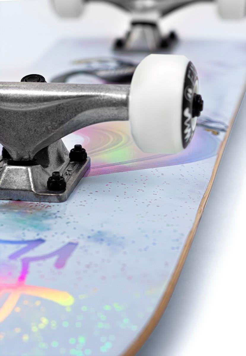 Close-up of the Enuff Skully Hologram White Mini Complete Skateboard, focusing on wheels and truck. Its 7.25" x 29.5" deck showcases pastel iridescent abstract patterns, reminiscent of a Skully Hologram, against a plain backdrop.