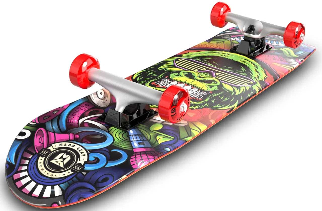 The Madd Gear MGP Pro Series BOOM'N LE Complete Skateboard (8" x 31") features red wheels, black trucks, and vibrant graffiti artwork with a green gorilla wearing sunglasses on the deck.