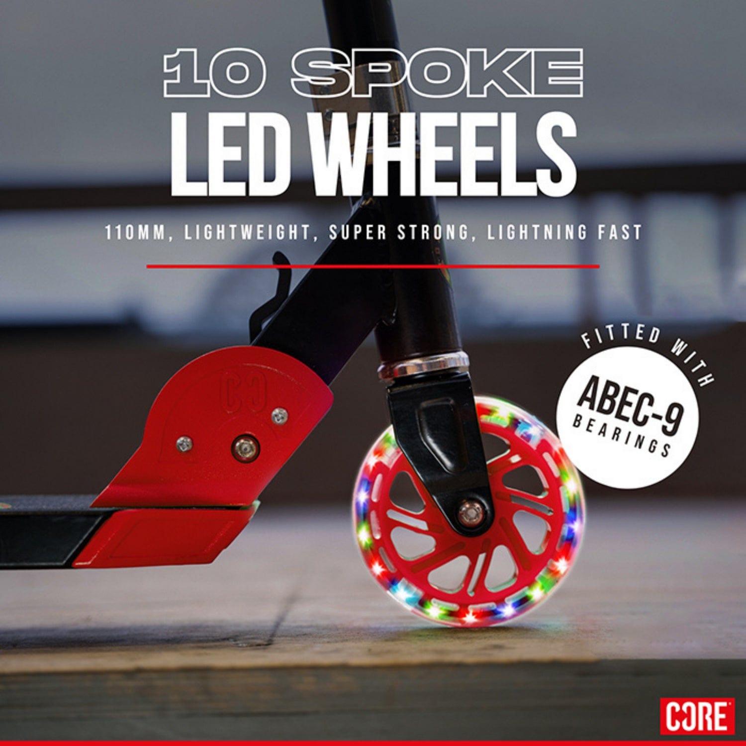 A close-up of a 10-spoke LED wheel with a red frame and colorful lights on the CORE Foldy Kids LED Foldable Kick Scooter. Features: 110mm size, lightweight, super strong, fast, ABEC-9 bearings. Ideal for kids' scooters with adjustable handlebars. The Core logo appears at the bottom right.