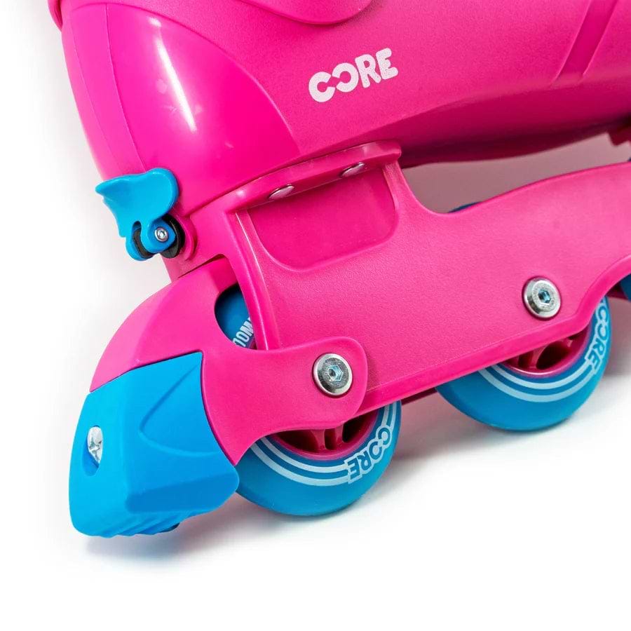 Close-up of the CORE Retro Adjustable Inline Skates in bright pink with blue wheels and toe stop, designed for ultimate comfort and performance, featuring the "CORE" branding on the side.