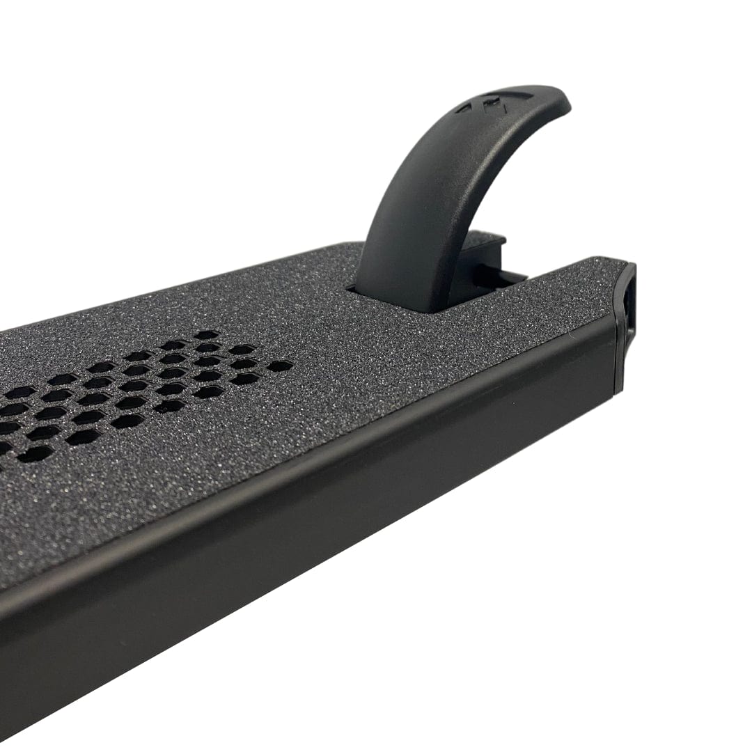 Close-up of a black metal surface with hexagonal ventilation holes and a raised black plastic handle, similar to the durable design of the Root Industries Invictus V2 Black Stunt Scooter Deck (4.8" x 20").