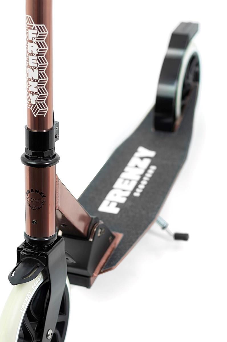 A close-up view of the Frenzy 205mm Dual Brake V4 Foldable Commuter Scooter in bronze highlights its black grips. The deck prominently displays the "Frenzy" branding, while its white 205mm wheels add to its appeal. Featuring a geometric handlebar design with an advanced cable folding system, this scooter is perfect for everyday commuting.