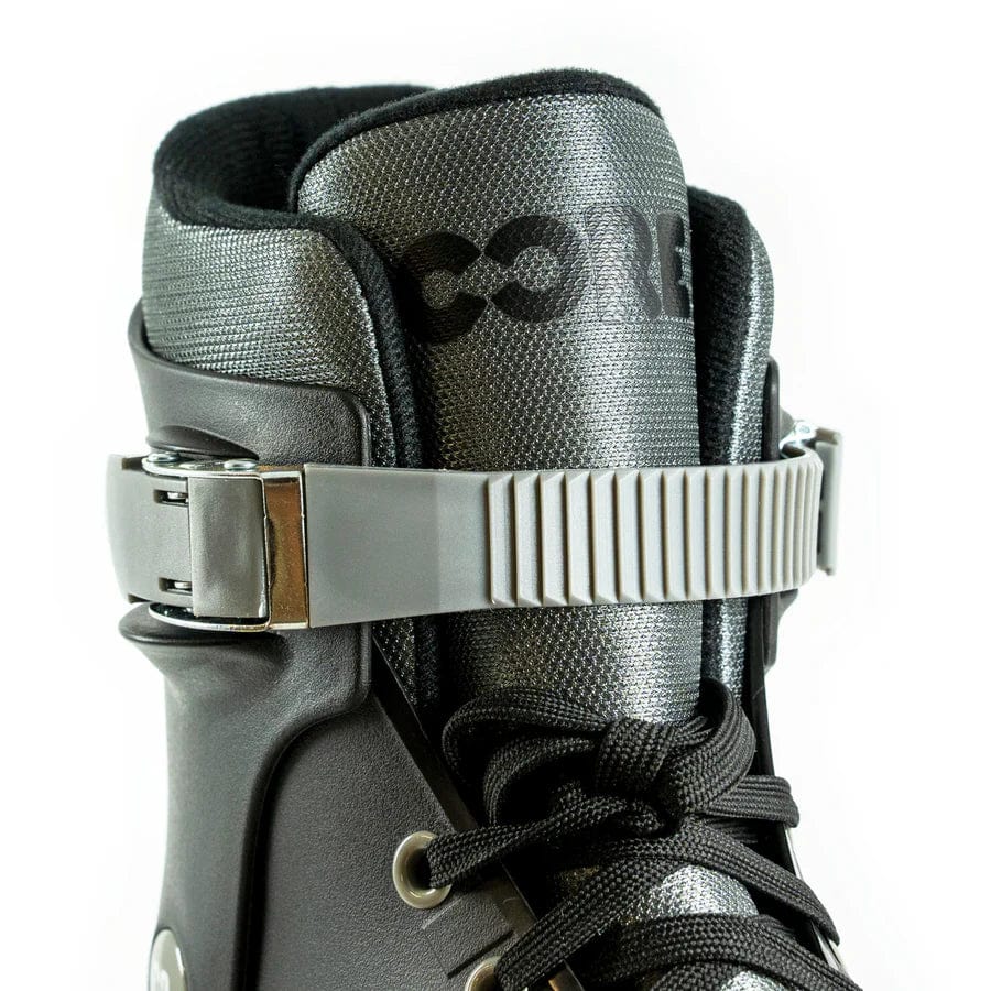 A close-up of the CORE Retro Adjustable Inline Skates - Black showcases a black boot with a gray buckle strap and black laces. The upper tongue is labeled "CORE," and the boot features a textured finish for both style and durability. These skates are designed for performance comfort and offer adjustable settings to ensure the perfect fit every ride.