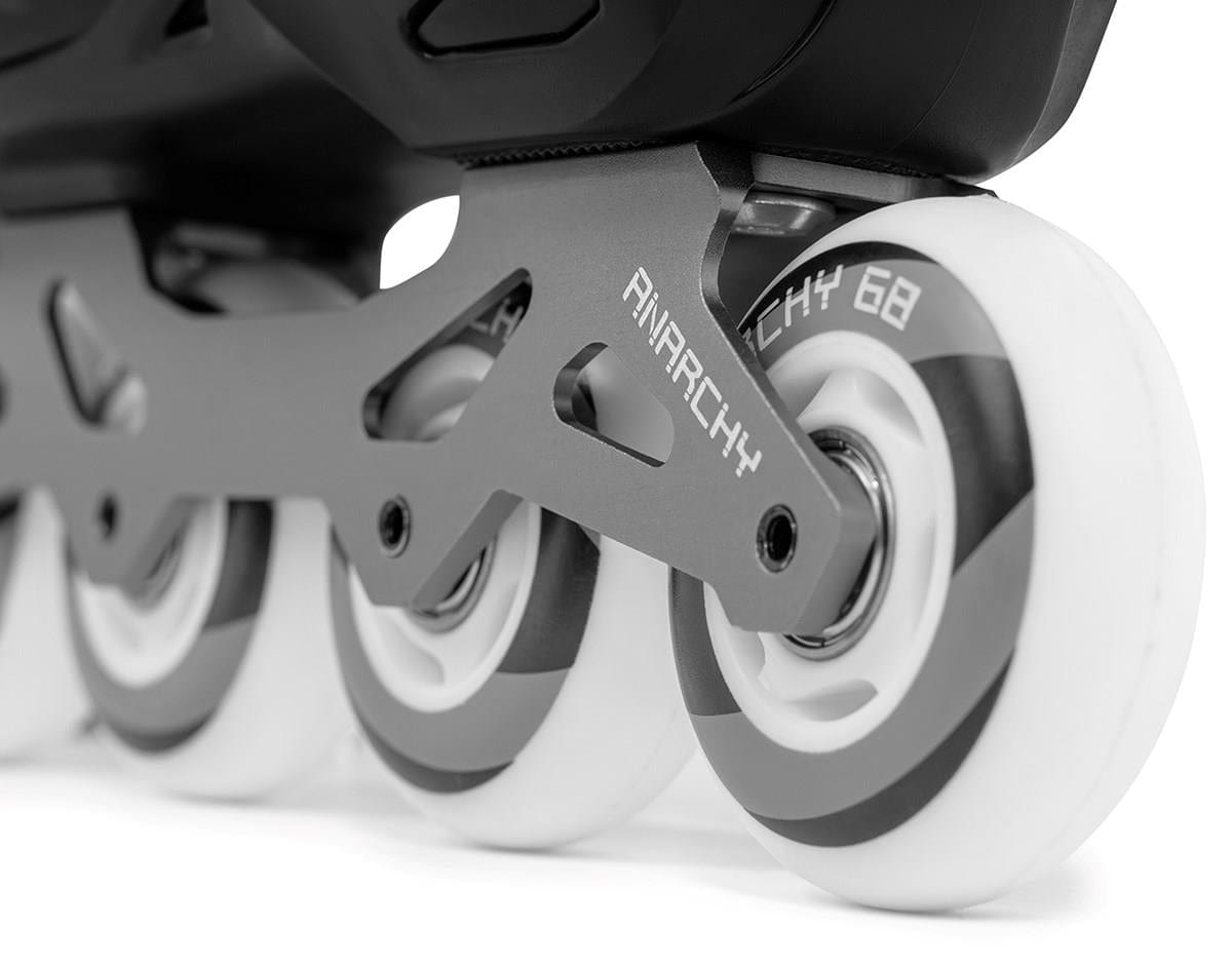 The Anarchy Unity Adjustable Inline Skates feature white tires, an aluminum frame, and a sleek modern design, combining style and functionality in black.