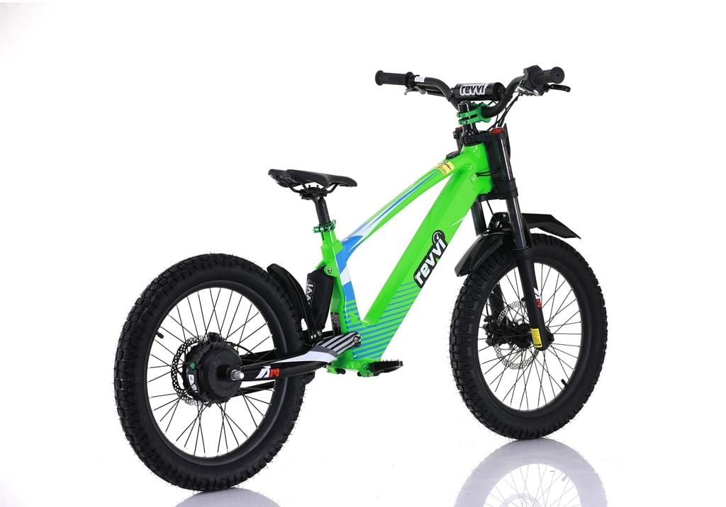 The Revvi 20" Kids Electric Balance Bike - Green features a geometric frame design, black off-road tires, front suspension forks, speed settings, and a rear hub motor. It's showcased against a white background with a sturdy build.