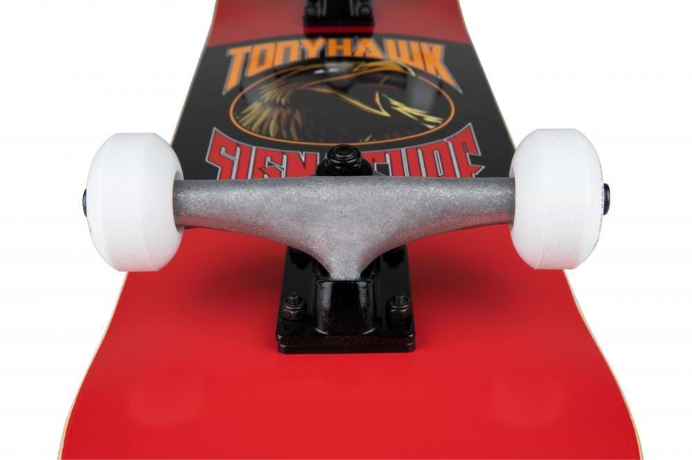 Close-up of the Tony Hawk SS 180+ Bird Logo Red Complete Skateboard (8" x 31.5") with silver trucks and white wheels, featuring the bold Tony Hawk graphic—ideal for beginners.