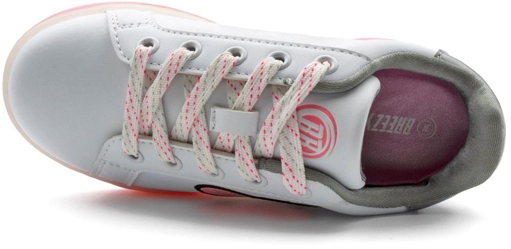 The Breezy Rollers Blast Shoes - Pink by Breezy Rollers feature a white upper with pink accents, pink-speckled laces, a cushioned pink insole, and a circular logo on the tongue. These stylish shoes include the patented wheeled system.