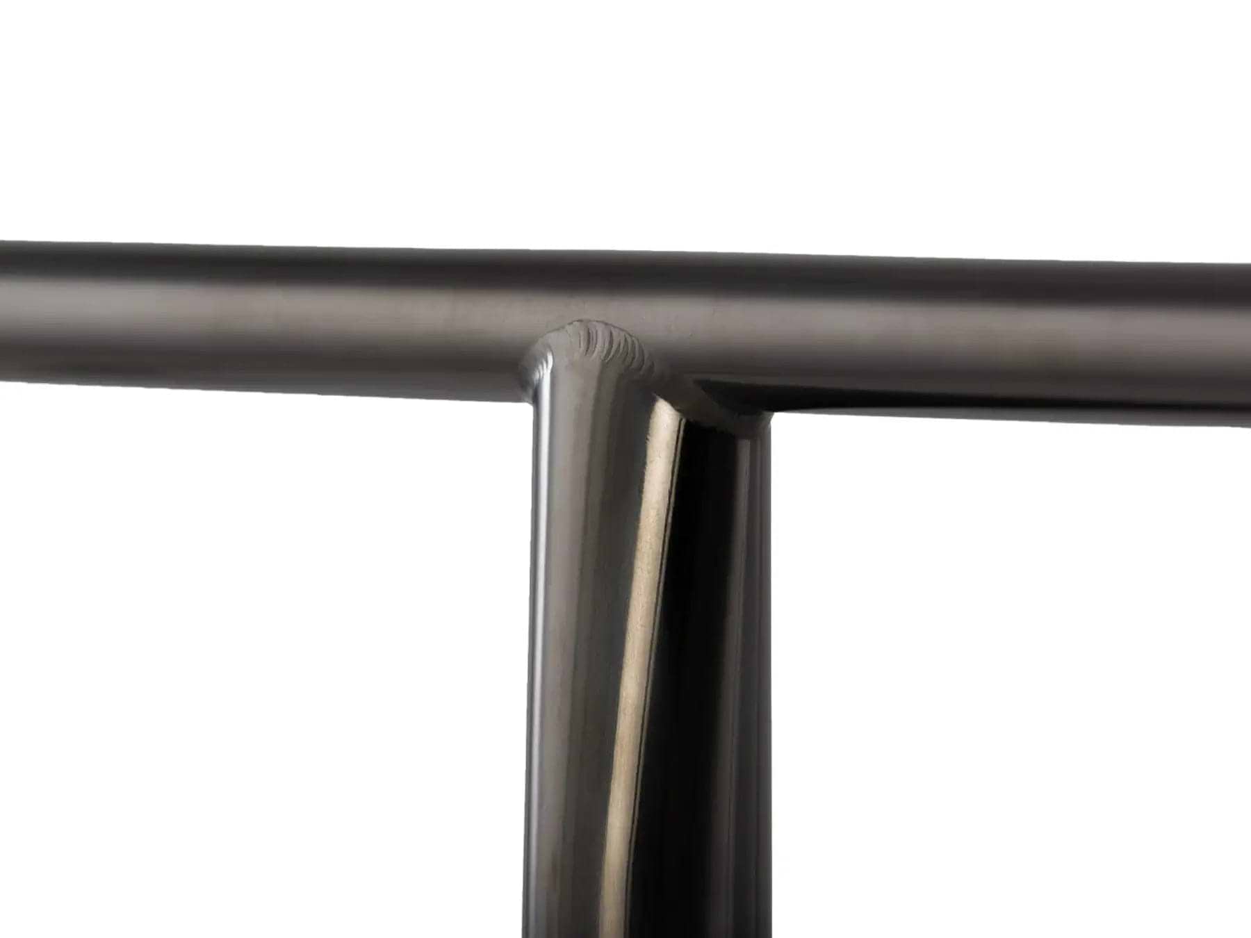 The close-up showcases the Lucky Obsidian Titanium Oversized SCS Stunt Scooter T-Bar in black, featuring a sleek metal joint with a T-shaped intersection. The smooth, shiny surface reflects light, emphasizing the precise connection of cylindrical rods, reminiscent of the artistry seen in Lucky's Titanium Scooter Bars.