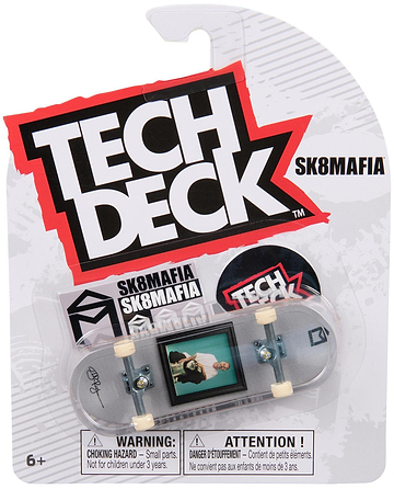 The Tech Deck 96mm M57 Fingerboard - SK8Mafia by Tech Deck features the SK8MAFIA logo and graphic skateboard design. Suitable for ages 6+, it comes in packaging with safety warnings. Perfect for fans of 96mm fingerboards.
