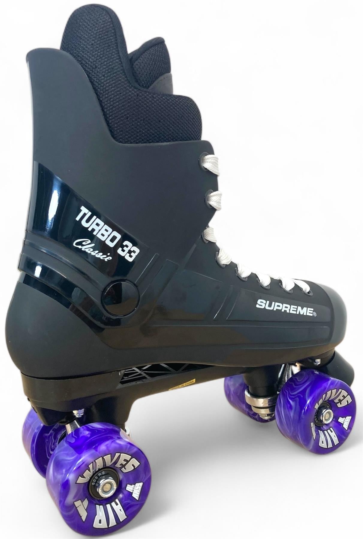 The Supreme Turbo 33 Nylon Quad Roller Skates in black feature eye-catching purple swirl wheels and white laces. With a durable nylon build, these stylish Supreme skates blend top performance for enthusiasts. Shown on a plain white background.