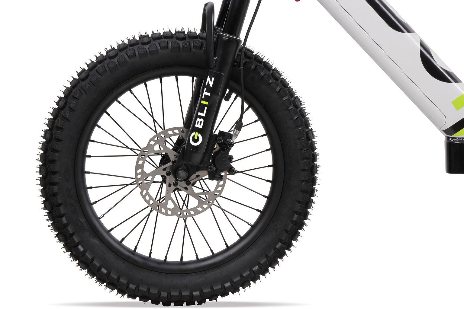 Close-up of the Duo 18" Blitz Kids Electric Balance Bike (White/Black) front fat wheel, with thick treaded tire, disc brake, black fork labeled “BLITZ,” and part of the white frame by Duo.
