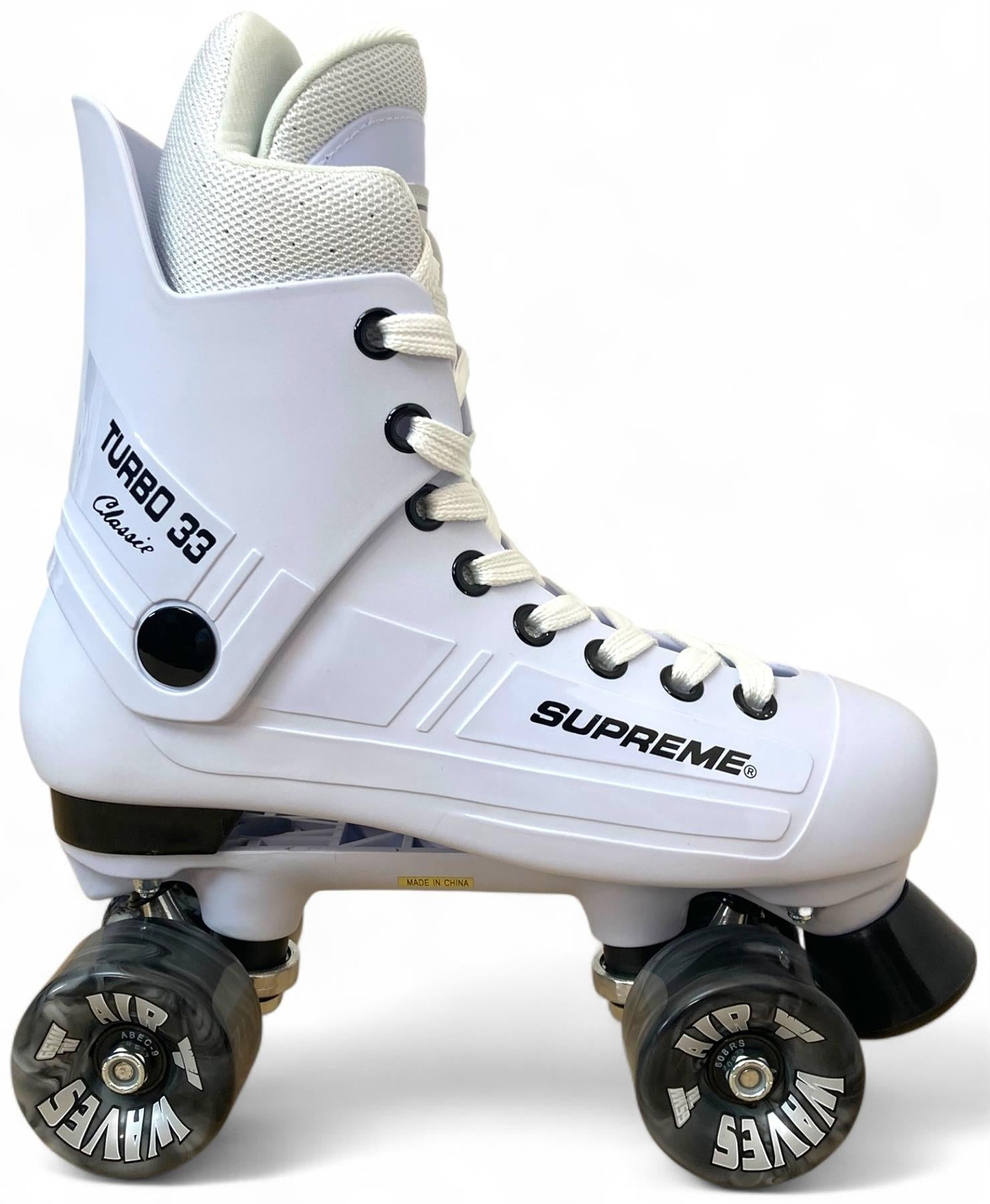 The Supreme Turbo 33 Nylon Quad Roller Skates in white feature black swirl wheels, white laces, a high ankle collar, and retro styling. "Supreme Turbo 33" and "Turbo 33 Classic" appear on the side for extra style.