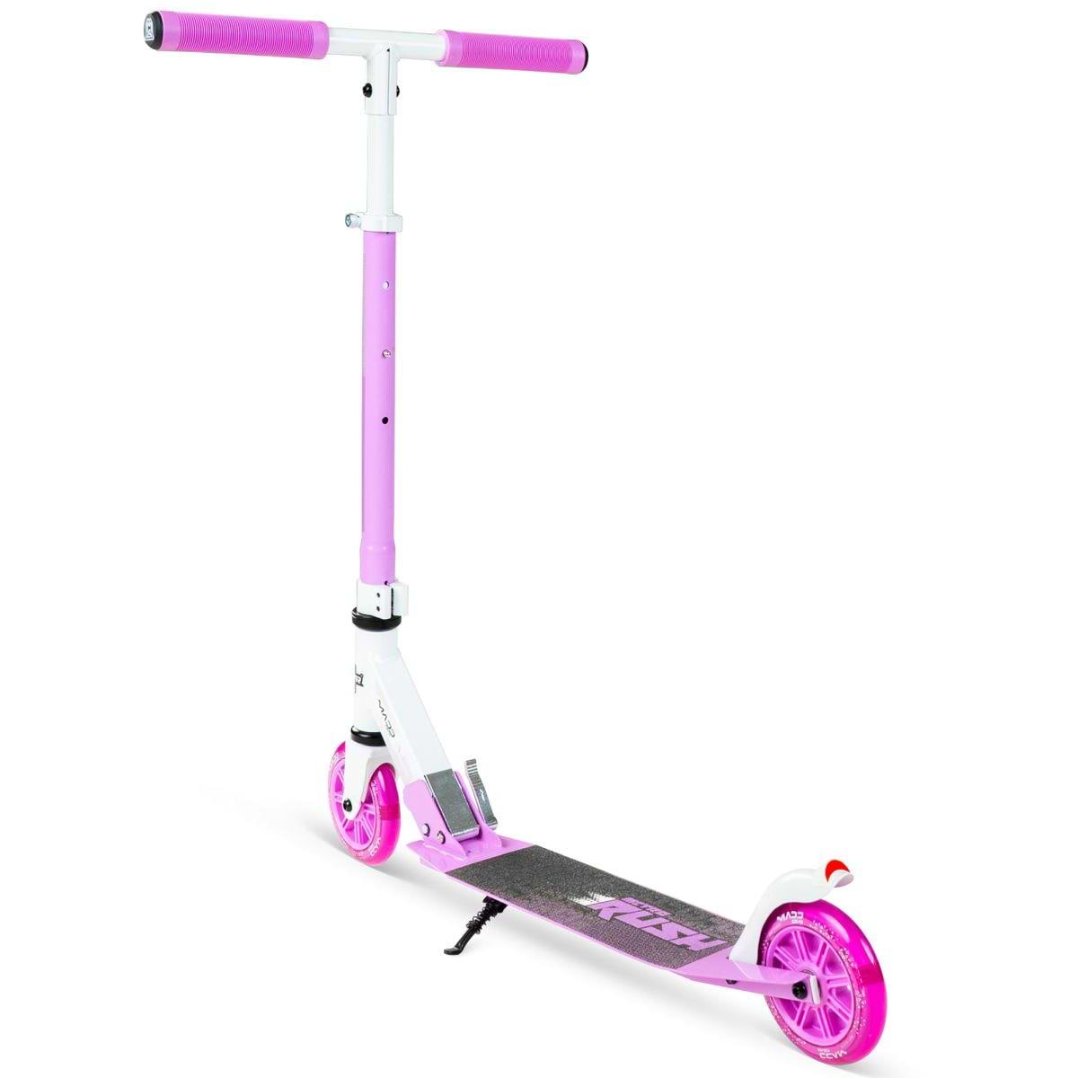 The Madd Gear Metro Rush 125 Kids Foldable Scooter in white/purple features pink handlebars, light-up pink wheels, an adjustable handlebar, and a black grip deck. It stands upright on its kickstand against a white background.