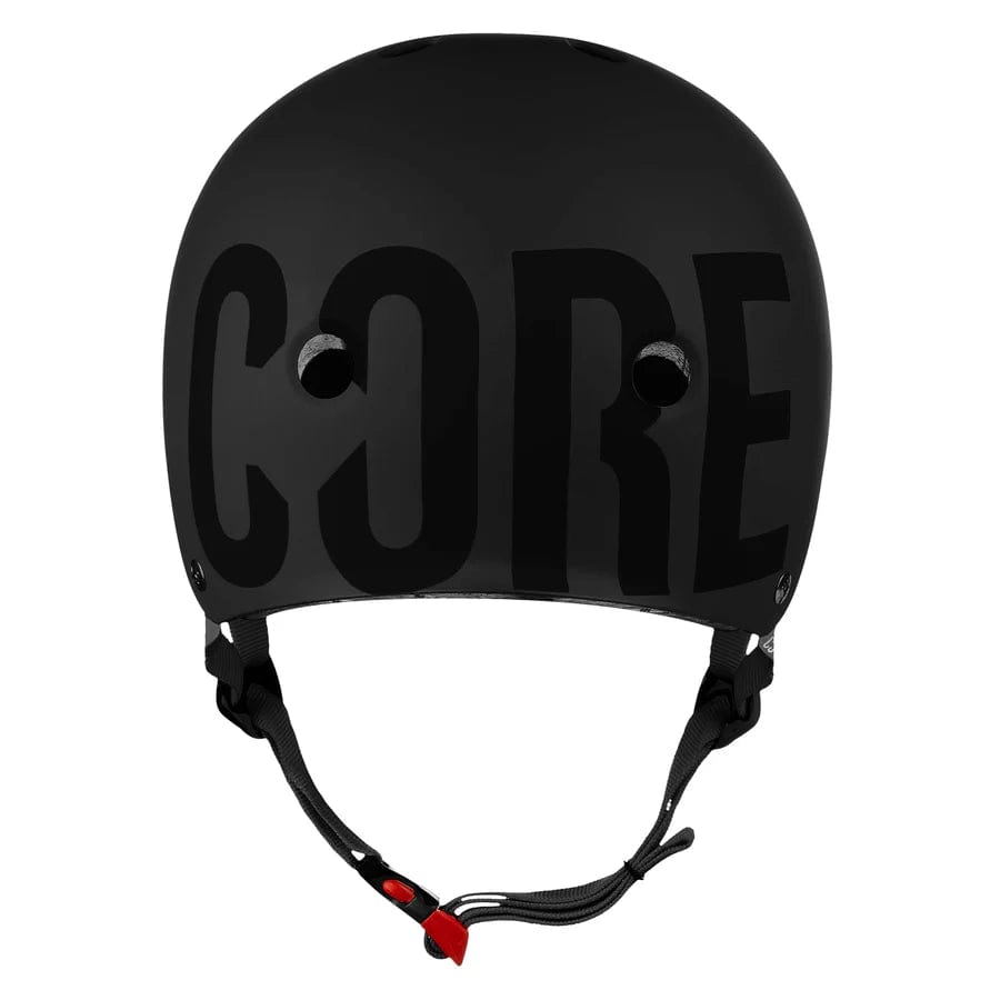 The CORE Street Skate / Scooter Helmet in Stealth Black offers both comfort and style, featuring Lux Pads for an ideal fit, ventilation holes, an adjustable chin strap with a red clasp, and the prominent "CORE" logo across the front.