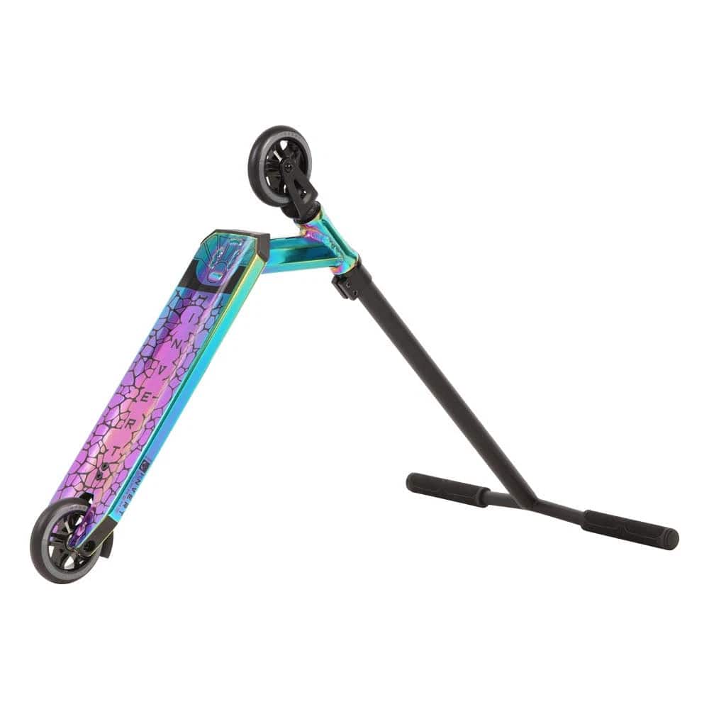 The Invert Supreme 2.5-8-13 Complete Stunt Scooter in Neochrome/Black features a durable aluminum deck with cracked pattern, black handlebars and wheels—perfect for intermediate riders. Shown propped on its side against a white background.