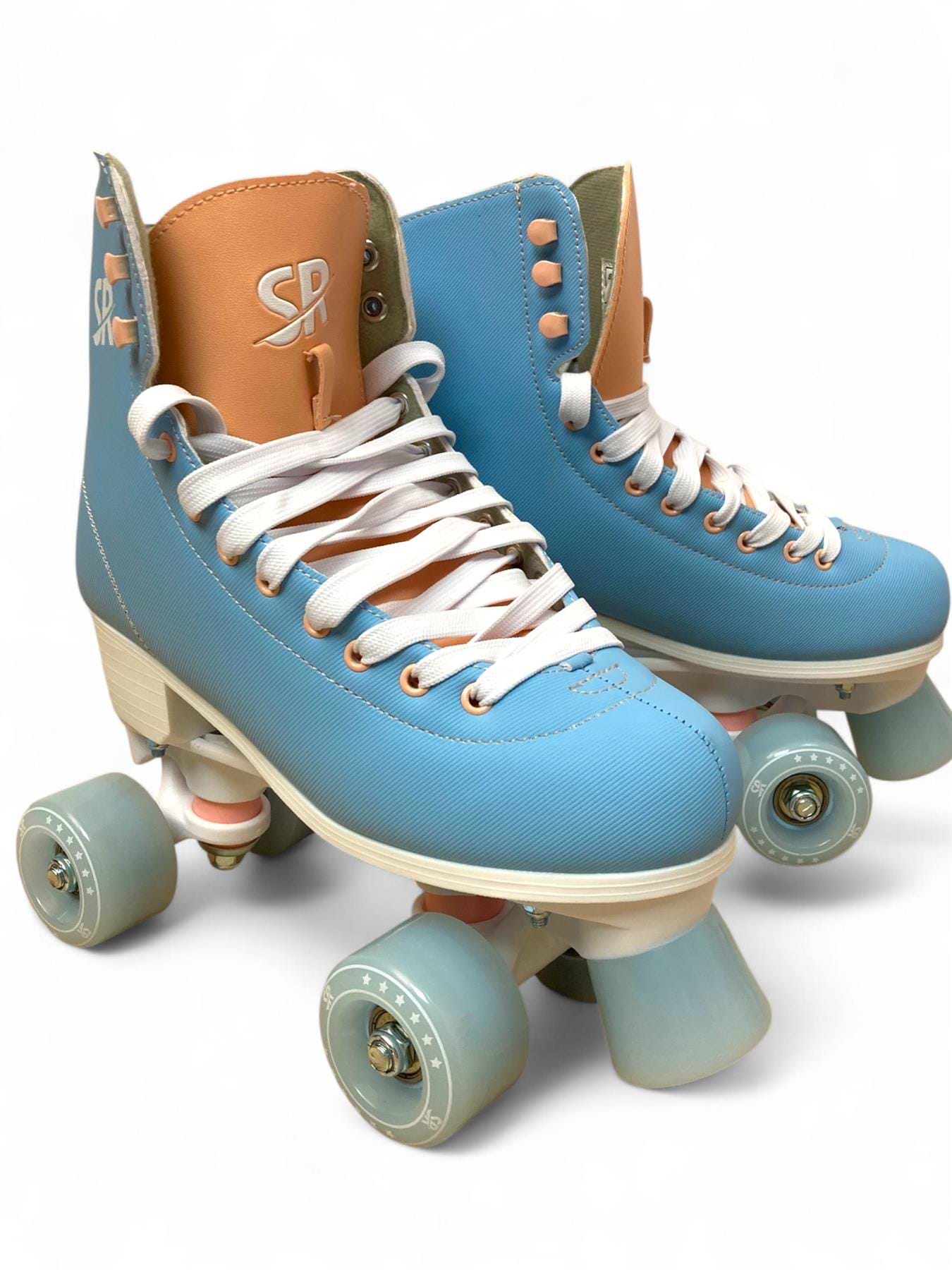 The Supreme Malibu Quad Roller Skates – Light Blue by Supreme feature retro-style light blue and tan boots, white laces, and light blue wheels—ideal beginner skates for recreational use, shown on a plain white background.
