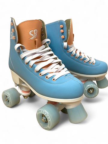 The Supreme Malibu Quad Roller Skates – Light Blue by Supreme feature retro-style light blue and tan boots, white laces, and light blue wheels—ideal beginner skates for recreational use, shown on a plain white background.