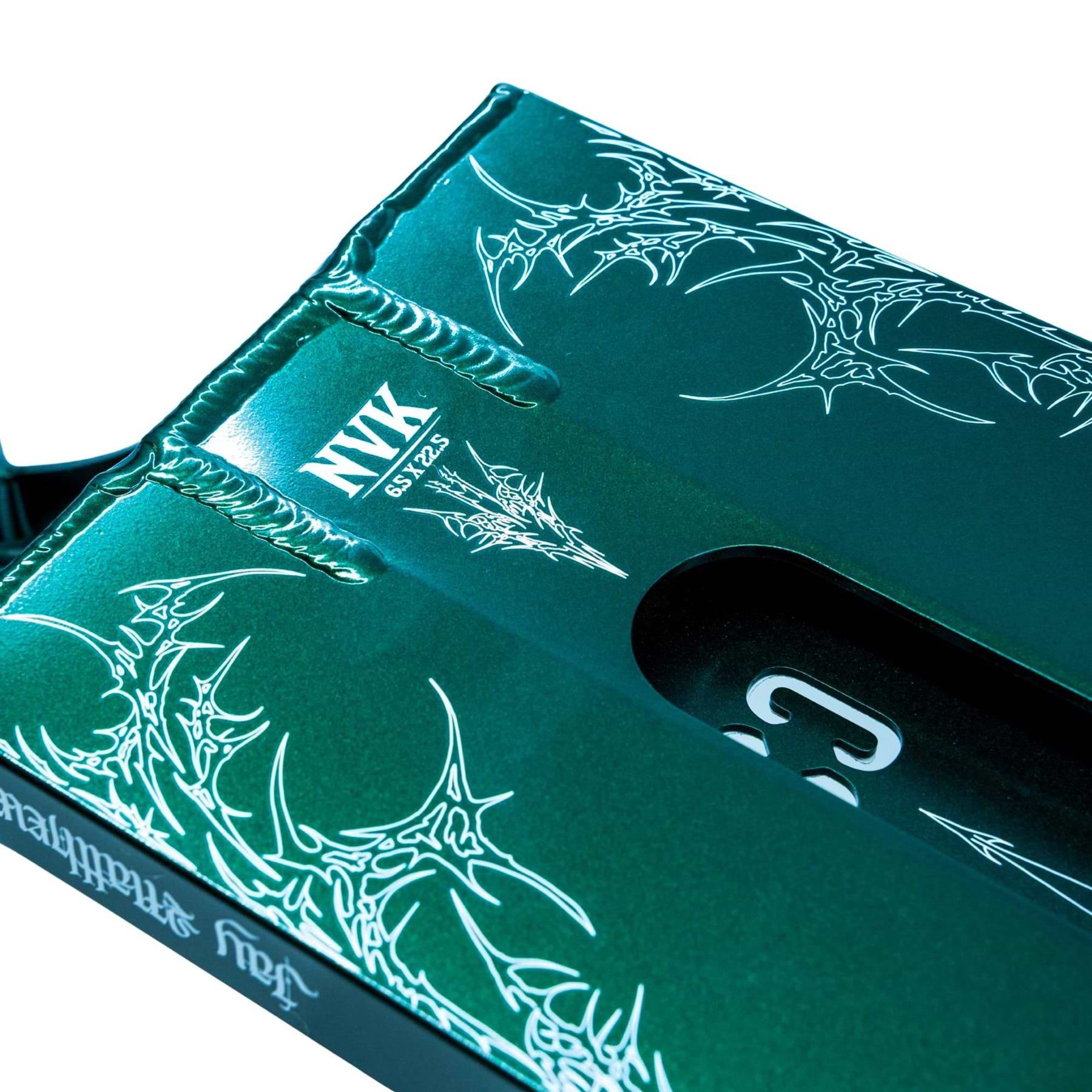 Close-up of the CORE ST3 Forged Green J.Matthews Signature Street Stunt Scooter Deck (6.5" x 22.5"), featuring intricate white graphics and bold "NYX SBYZ2" text, with part of its wide cutout and hardware also visible.