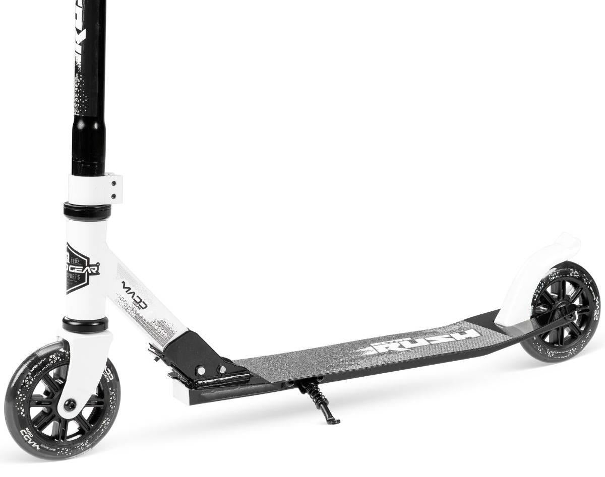 The Madd Gear Metro Rush 125 Kids Foldable Scooter in white/black features an adjustable handlebar, two 125mm LED wheels, textured deck, kickstand, and fenders on both wheels; shown on a white background.