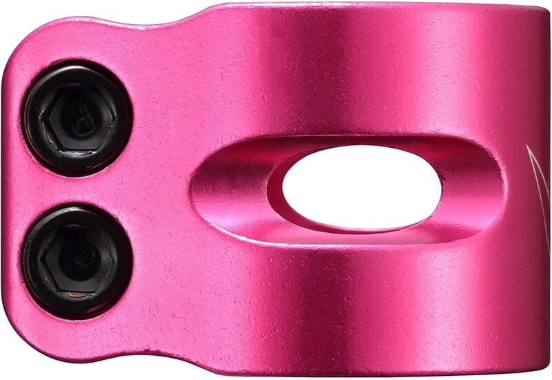 A close-up of the Blunt Envy Twin Slit 2 Bolt Oversized Scooter Clamp in metallic pink showcases its design for stunt scooters, featuring two black bolts on the left side and an oval cutout in the center. This lightweight scooter clamp from Blunt Envy boasts a satin finish with subtle reflections.