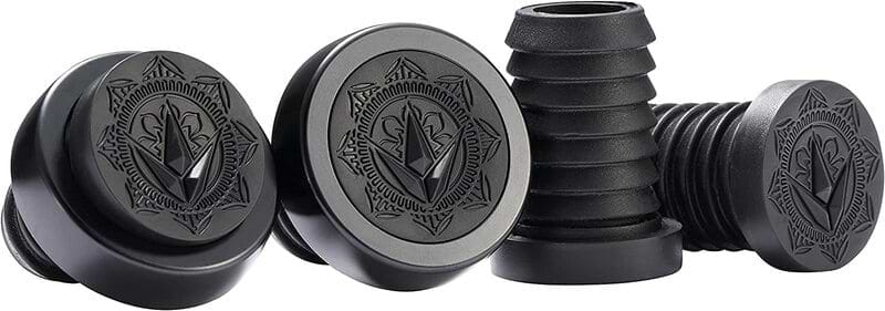 A collection of black, cylindrical Blunt Envy ends showcases decorative geometric patterns with a leaf motif on the top, drawing inspiration from Will Scott Signature artistry. In a group display, one is inverted to unveil its ribbed side, mirroring the precision seen in CNC Halo rings.